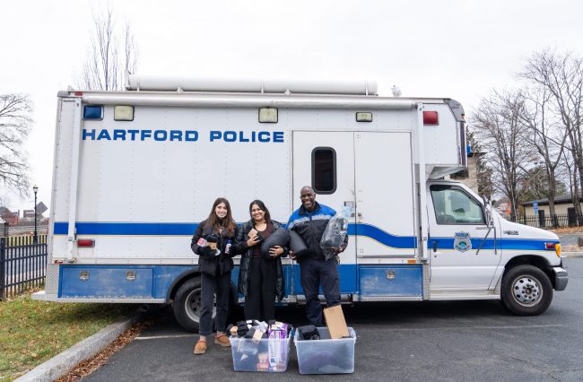 Students Naime Gilani and Narayani Ballambat with Hartford Police Officer Jim Barrett