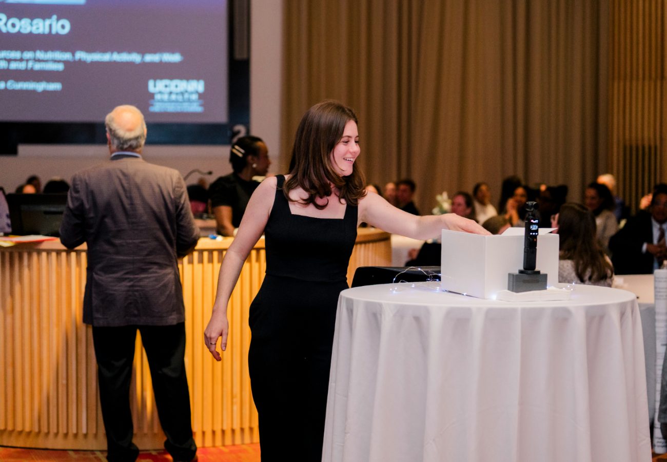 Julia Prescott places thesis cover page into bin