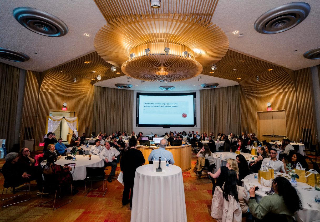 Wide panel shot of all attendees at the graduation dinner