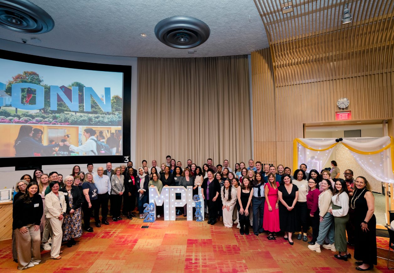All students and attendees smiling around MPH letters in a group photo