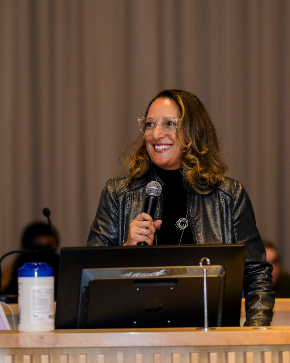 Dr. Brown smiling at podium in the academic rotunda