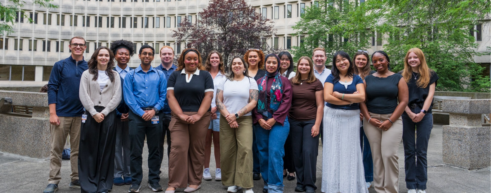 Fall 2025 class of MPH students smiling in a group photo in the courtyard