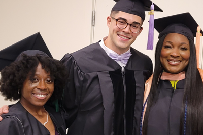 3 students in graduation gowns